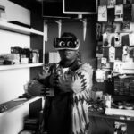 Customer Experiences - Black man in VR goggles in electronics store