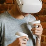 Visual Content - Young male with VR goggles and controllers
