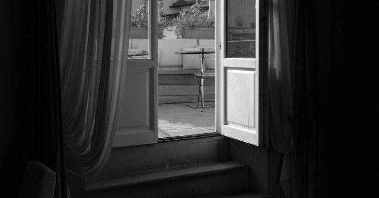 Open Rates - A black and white photo of a window with a view