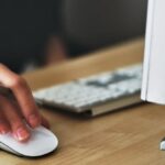 Cost-Per-Click - Person Holding Apple Magic Mouse