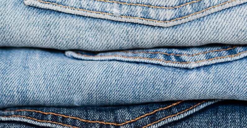 Quality Score - Stack of blue jeans arranged by color