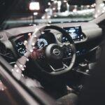 Brand Awareness - A car interior at night with the steering wheel and dashboard